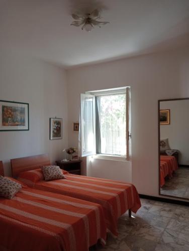 a bedroom with two beds and a mirror at Roses House in Sestri Levante