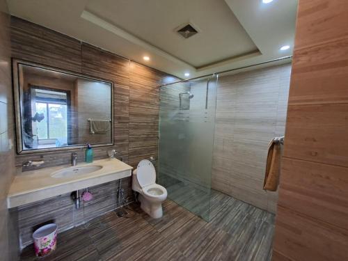 a bathroom with a shower and a toilet and a sink at Private 1 BHK Suite - Islamabad, Bahria Town in Rawalpindi
