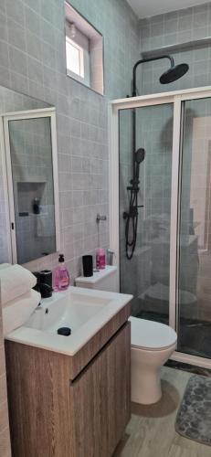 a bathroom with a sink and a toilet and a shower at Ines Studio T0 - Inforsal in Espargos