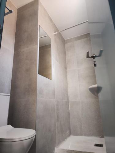 a bathroom with a toilet and a shower at Golden Sun Rooms - Adults Only in Ayia Napa