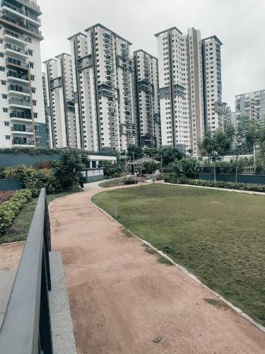 a park in a city with tall buildings at The Zenith Stay in Hyderabad