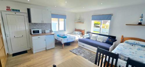 a small room with a kitchen and a living room at Four Winds Holiday Let in Nairn