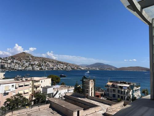 a view of a city and the water with buildings at Vila Behar - Penthouse Apartment with seaview in Sarandë