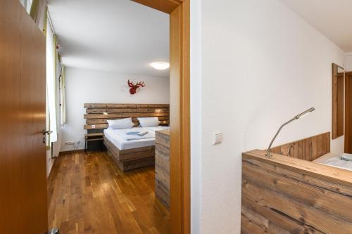 a bedroom with a bed and a tub in a room at Gasthof Rebstock in Friedrichshafen