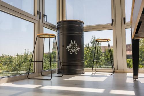 a large black barrel in a room with windows at Gite des cigognes in Kintzheim