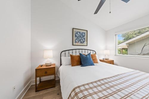 a white bedroom with a bed and a window at The Festival Retreat KING Bd Cajun Luxury Book Now in Lafayette