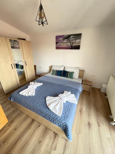 a bedroom with a bed with two white towels on it at Villa 80 Kodra e Diellit in Tetovo