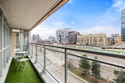 a balcony with a view of a city at Spacious 3BR Condo w Patio & Skyline Views in Toronto