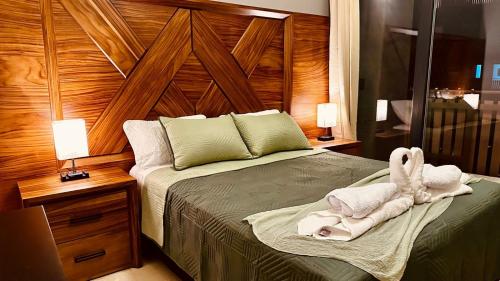 a bedroom with a bed with two towels on it at Jungle Guardian - Rooftop Pool & Beach Club in Zona Hotelera Tulum in Tulum