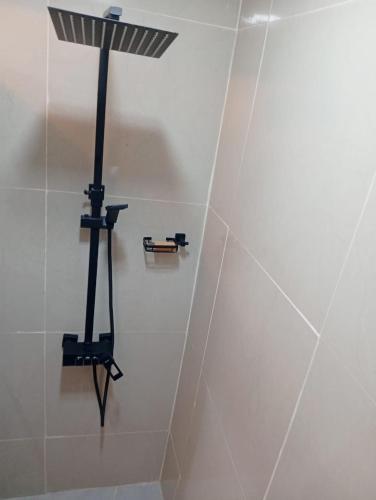 a shower with a light on a wall at Airport view apartment Marrakech in Marrakech
