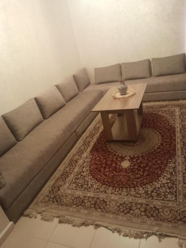 a living room with a couch and a coffee table at Airport view apartment Marrakech in Marrakech