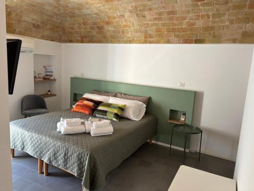 a bedroom with a bed with two towels on it at B&B Santa Chiara in Altamura
