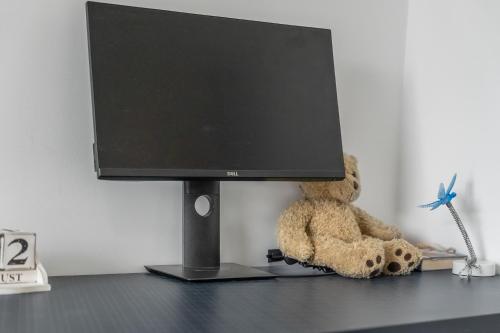 a teddy bear sitting in front of a computer monitor at Luxury 3BR with 2bath Near Westfield Stratford in London