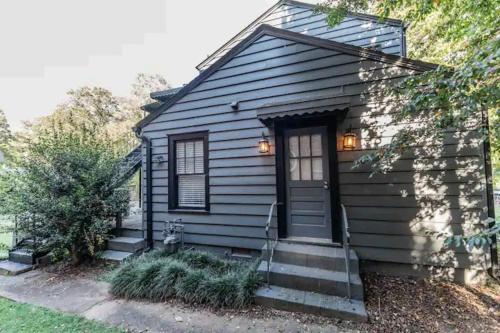 a tiny house with a blue door and stairs at 2 Kitchenssleeps 105 Car Parking in Atlanta