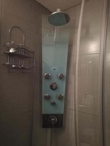 a shower with silver faucets in a bathroom at Studio au pied des pistes in Bagnères-de-Bigorre