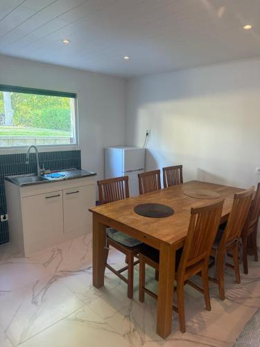 a kitchen with a wooden dining table and chairs at Guest house in Lyckeby in Karlskrona