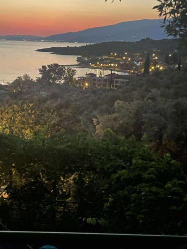 a view of a city and the ocean at sunset at Margianou Seaview Apartments 3 & 4 in Kálamos