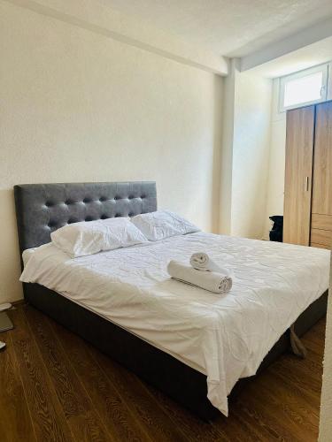 a large bed in a bedroom with a silver headboard at The Corner House in Delčevo