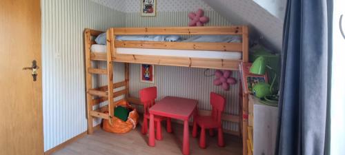 a doll house with a bunk bed and a table and chairs at Braunlage Vintage Quartier - Haus bis 16 Personen - 8 Zimmer WG in Braunlage