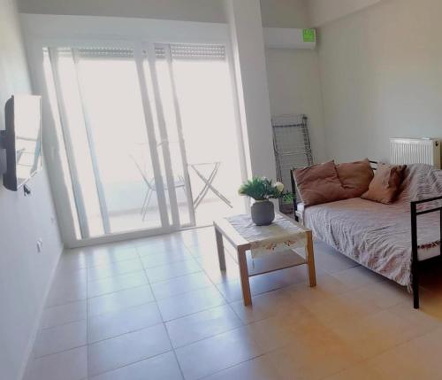 a living room with a couch and a coffee table at Thalassa View c3 in Khalkoútsion