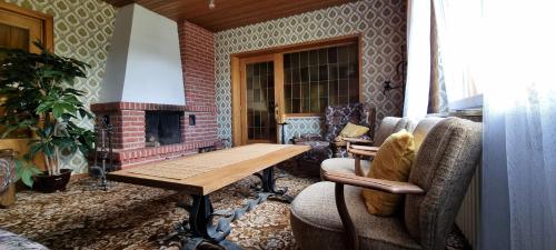 a living room with a table and a fireplace at Braunlage Vintage Quartier - Haus bis 16 Personen - 8 Zimmer WG in Braunlage