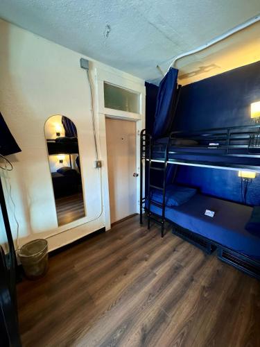 a room with two bunk beds and a mirror at ITH San Diego Mission Beach Backpacker Hostel in San Diego