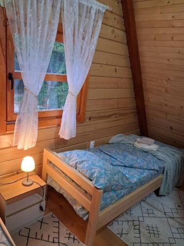 a bedroom with a bed and a window at Whisper of the Pliva in Šipovo