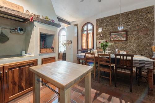 a kitchen and dining room with a table and chairs at Antico Podere Il Bugnolo in Poggibonsi