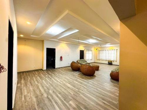 a large room with couches and chairs in it at Estben Guesthouse in Janman