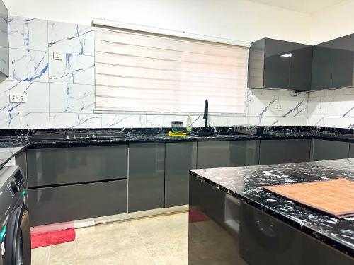 a kitchen with black and white marble counter tops at Estben Guesthouse in Janman