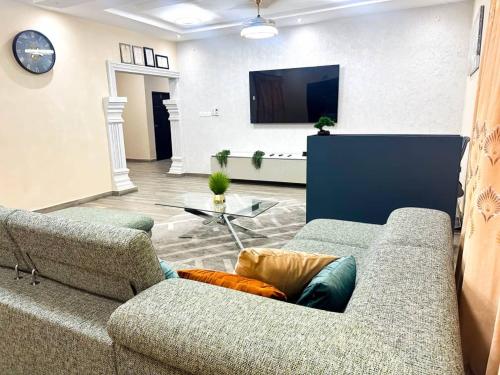 a living room with a couch and a flat screen tv at Estben Guesthouse in Janman