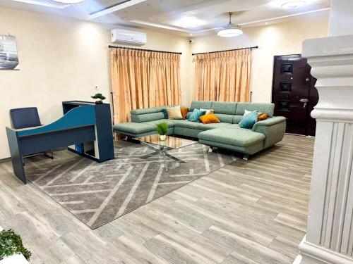 a lobby with two couches and a desk in a room at Estben Guesthouse in Janman