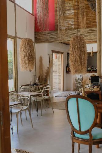 a dining room with tables and chairs and baskets at Soul Trancoso - Hotel Boutique in Trancoso