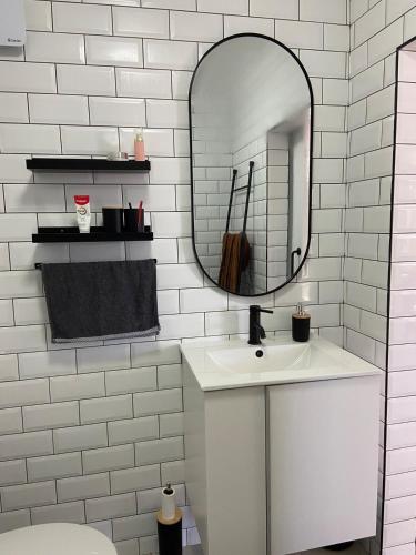 a white bathroom with a sink and a mirror at Stylish beachside Gem in Fish Hoek in Fish Hoek