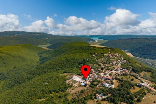 a red marker in the middle of a green hills at Villa PERLA VERDE in Labin