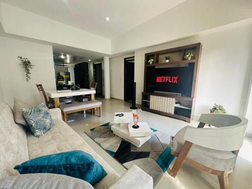 a living room with a couch and a television at Apartamento 301 Edificio Natura 54 in Ibagué