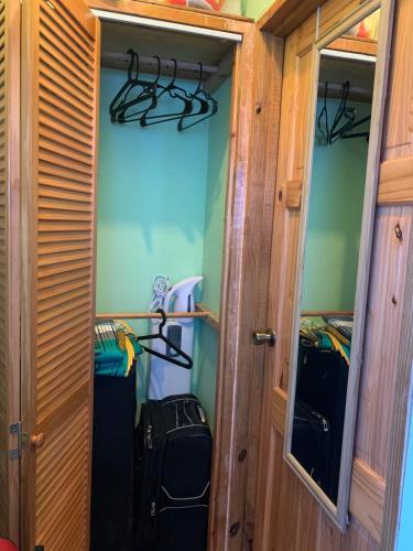 a small room with a door and a room with some luggage at Ocean Marine Villa Studio in Albion