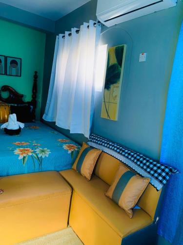 a living room with a couch in a blue room at Ocean Marine Villa Studio in Albion