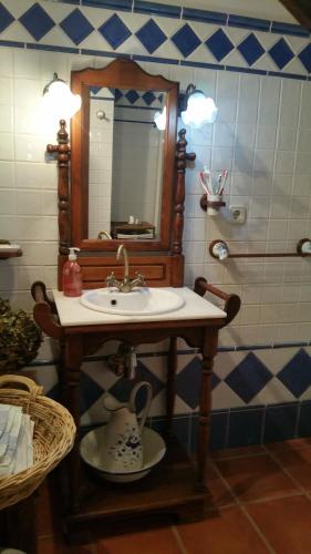 a bathroom with a sink and a mirror at Casa Golmar 20 in Cedeira