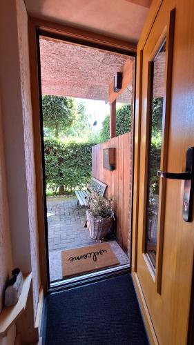 an open door to a porch with a potted plant at bei Thomas in Monschau