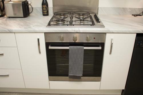 a kitchen with a stove and a towel on the oven at Tranquil Nest in Rushall