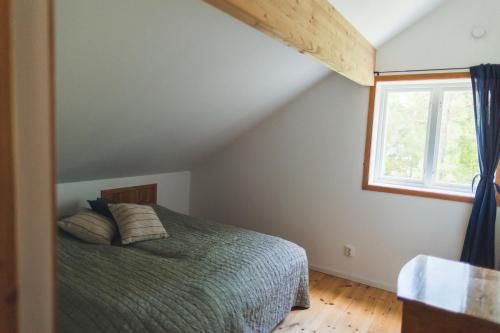a bedroom with a bed and a window at Summer house for the whole family in Öregrund