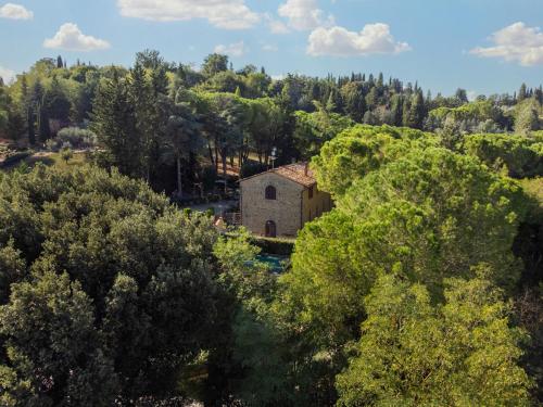 an old building in the middle of a forest at Antico Podere Il Bugnolo in Poggibonsi