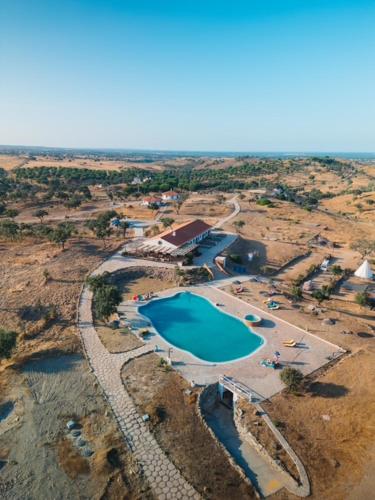 an aerial view of a resort with a swimming pool at Alpaca Farm And B&B - Mama Adama in Grândola