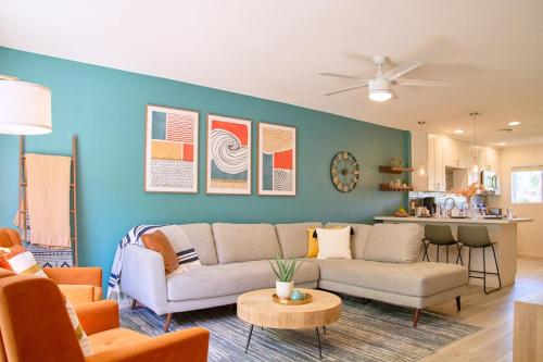 a living room with a couch and a table at The Scott Getaway - Walkable to Old Town, remodeled space, outdoor pool! in Scottsdale