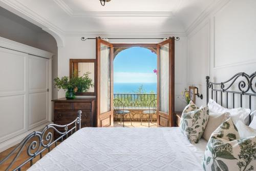 a bedroom with a bed and a view of the ocean at Villa Esposito in Massa Lubrense