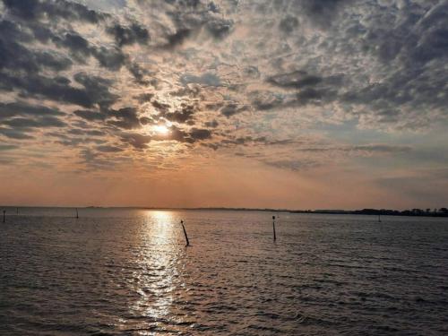 a sunset over a large body of water at 4 person holiday home in Rudkøbing-By Traum in Rudkøbing