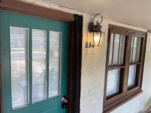 a green door with a window and a light next to it at Southern Perk -Coffee & Caffeine in Crestview