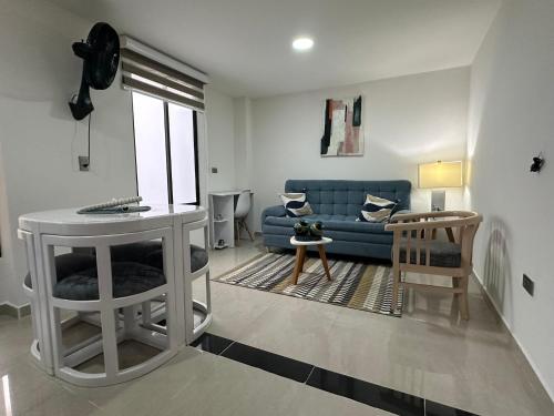 a living room with a blue couch and a table at Apartaestudios cerca centros comerciales in Ibagué