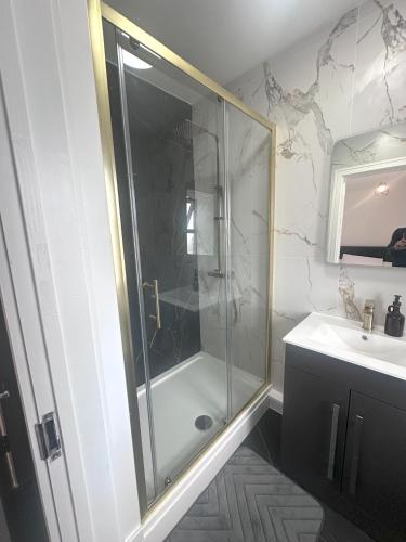 a bathroom with a glass shower and a sink at 2 Bedroom Flat in Marlborough House Cardiff Centre in Cardiff